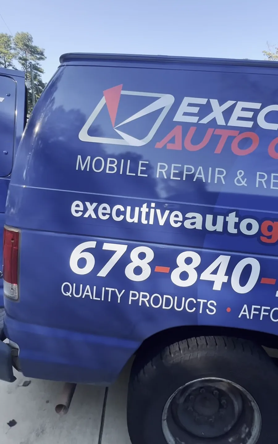 The Executive Auto Glass mobile service van, lettered with the phone number