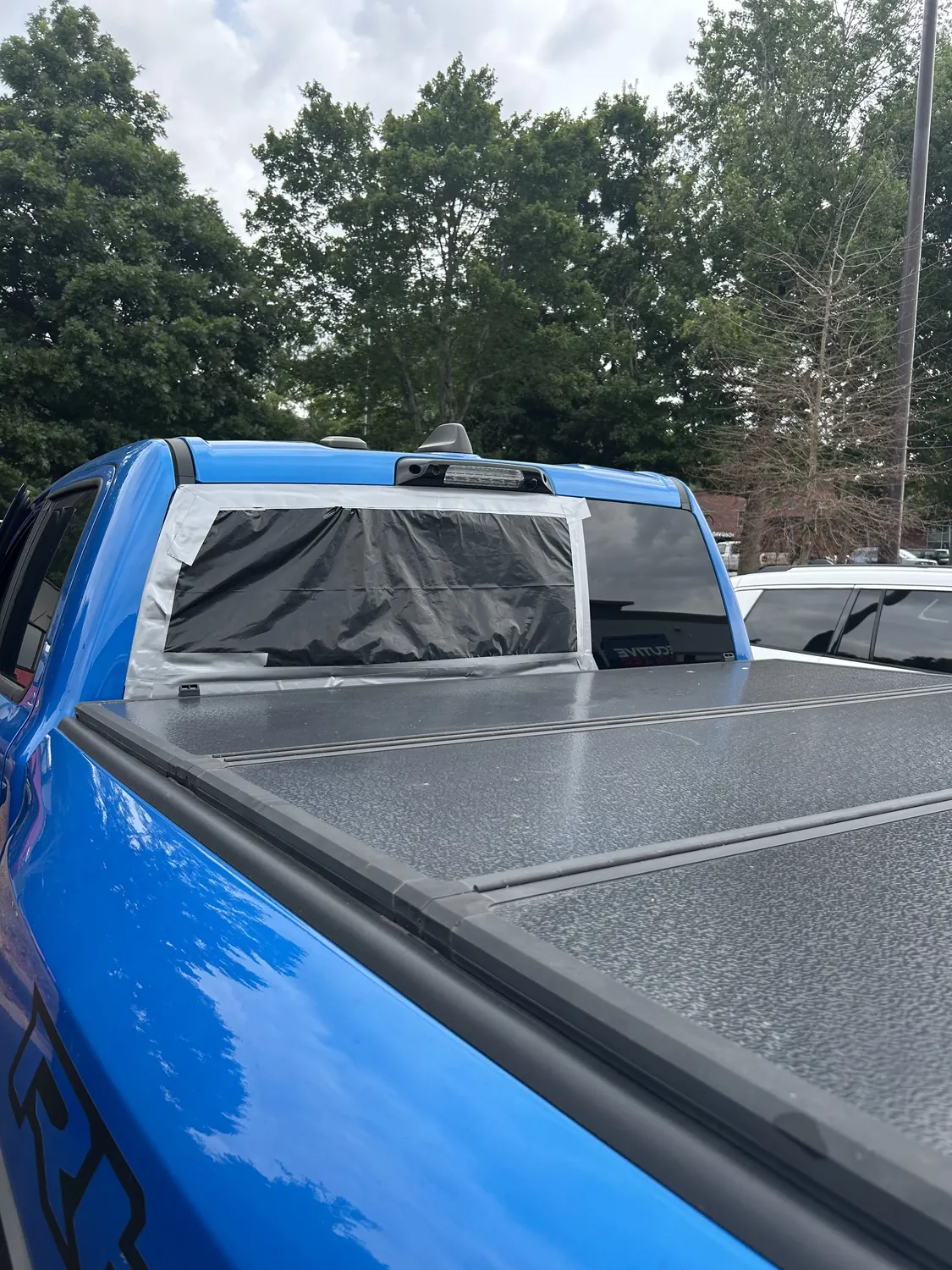 Pickup truck with a tonneau cover after rear glass service
