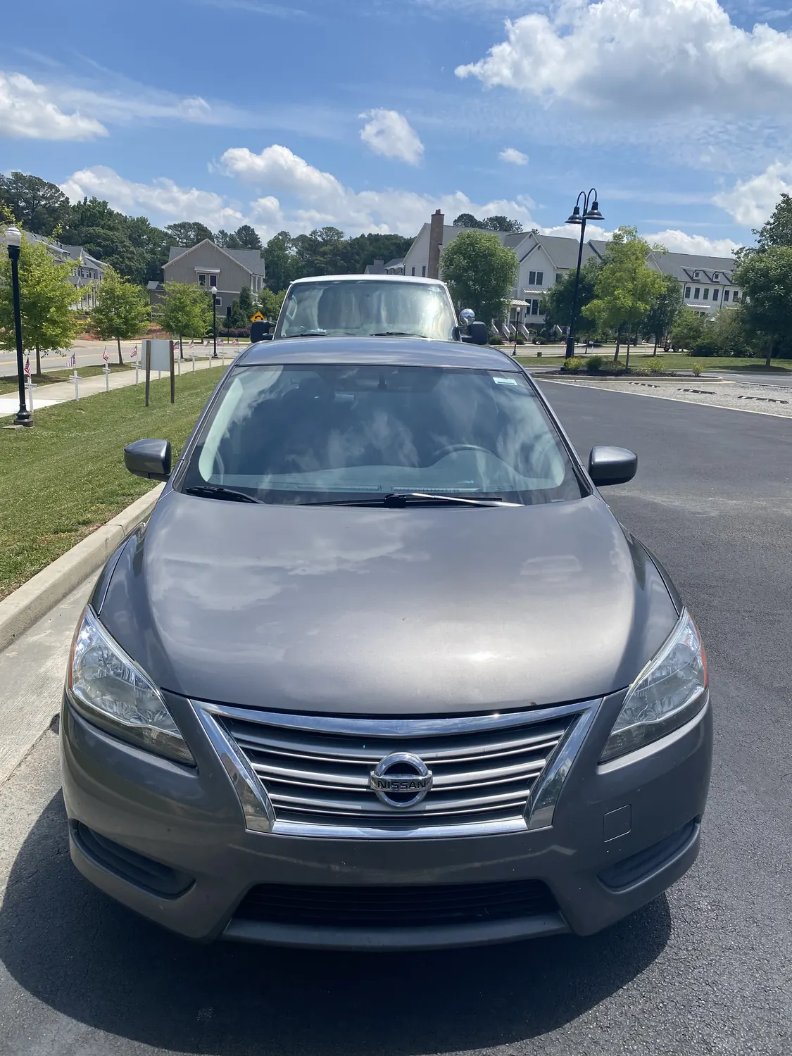 Gray sedan windshield replacement on the street