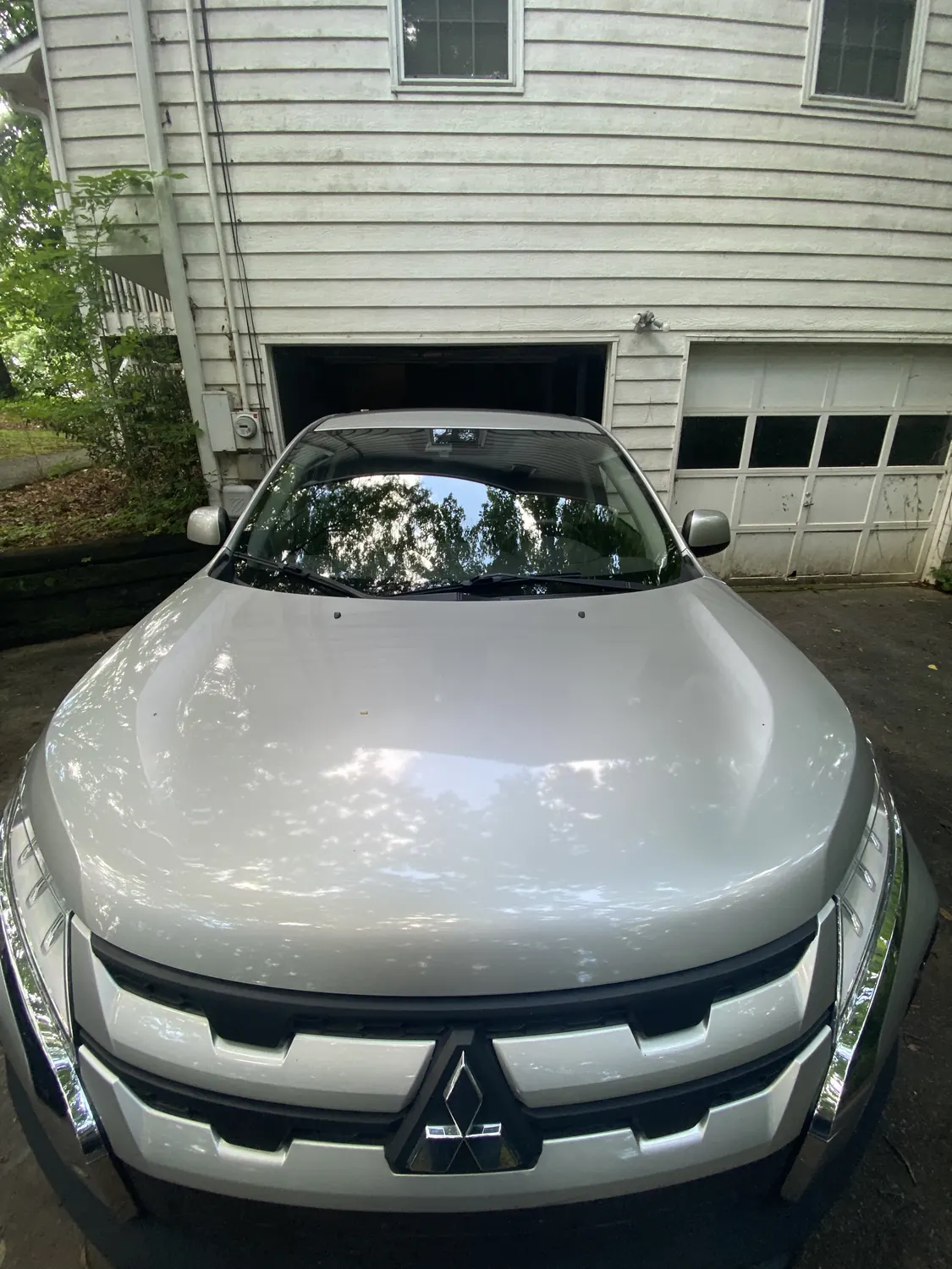 Silver pickup truck windshield replacement in a driveway