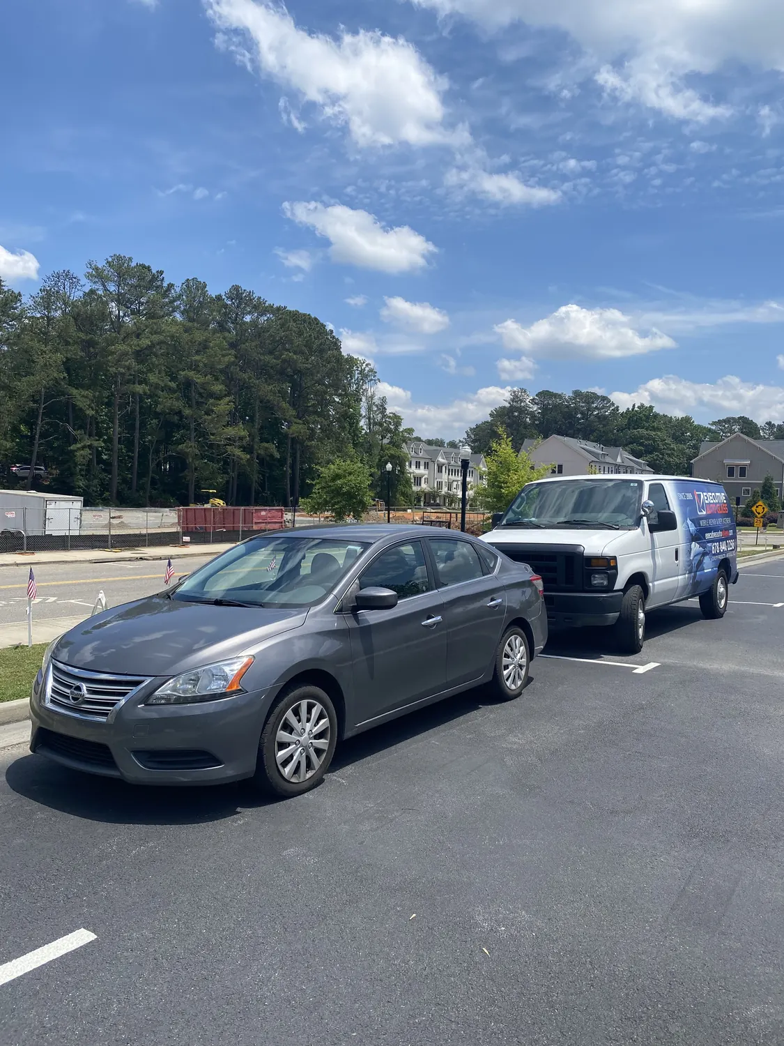 Silver sedan windshield replacement on a residential street