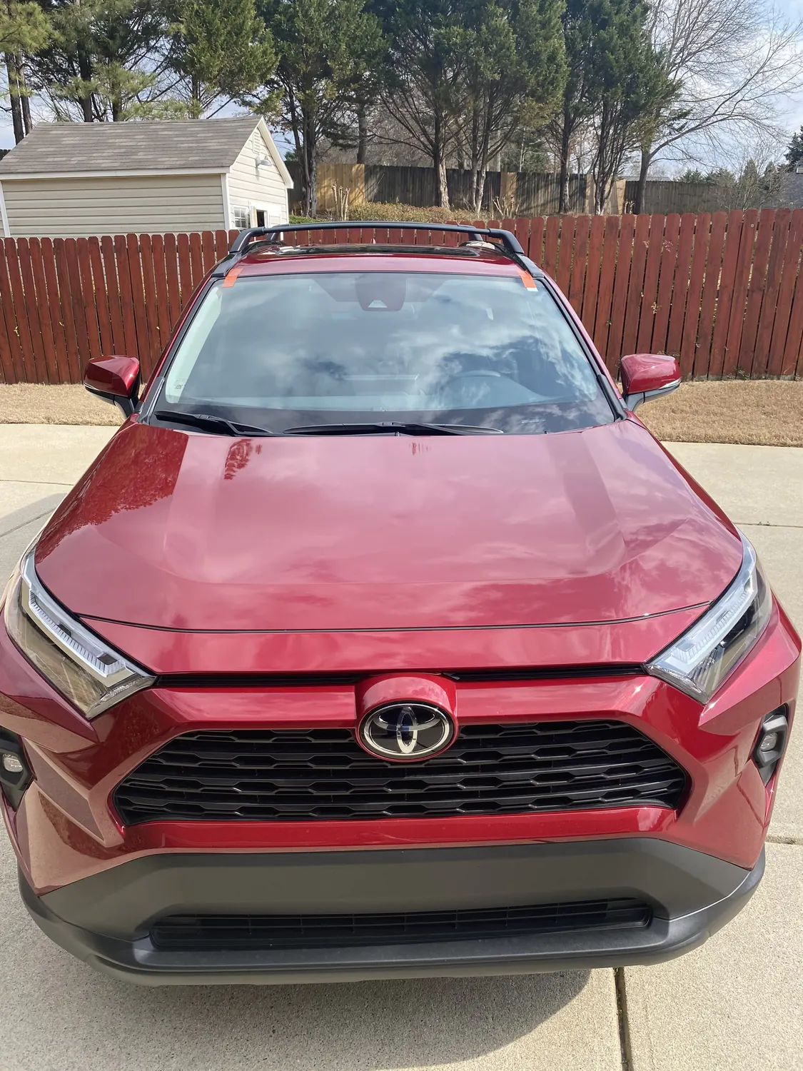Red Toyota RAV4 windshield replacement in a driveway