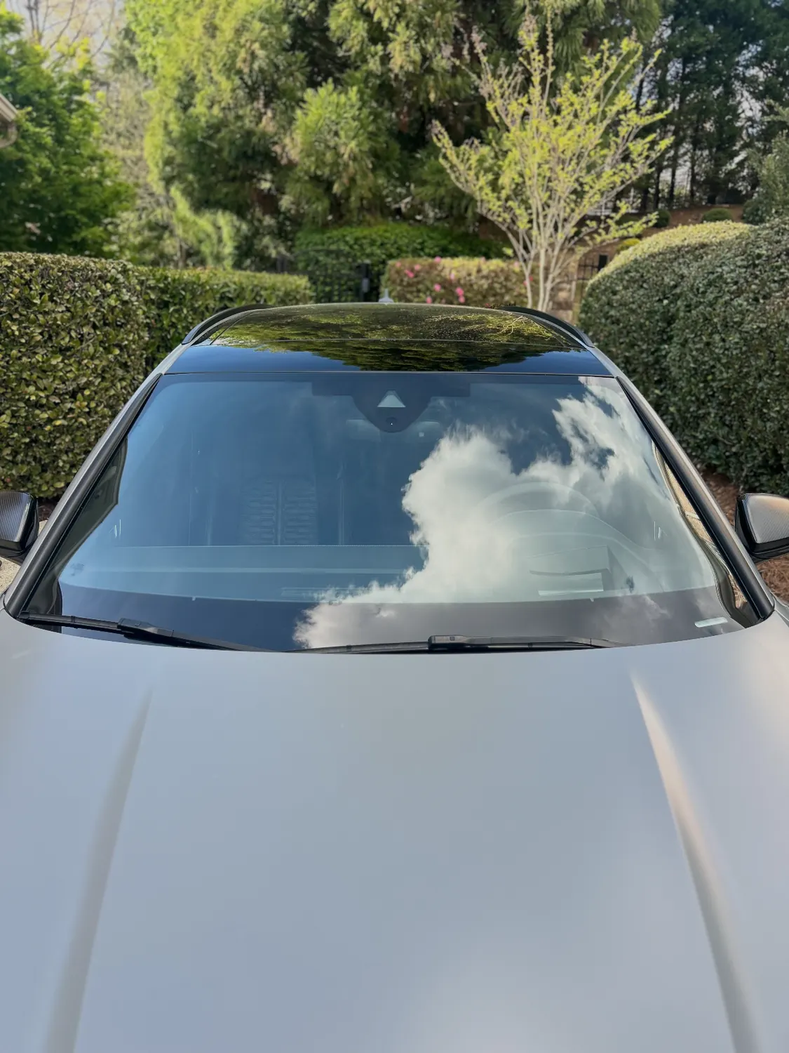 Finished windshield on a white car after a mobile replacement